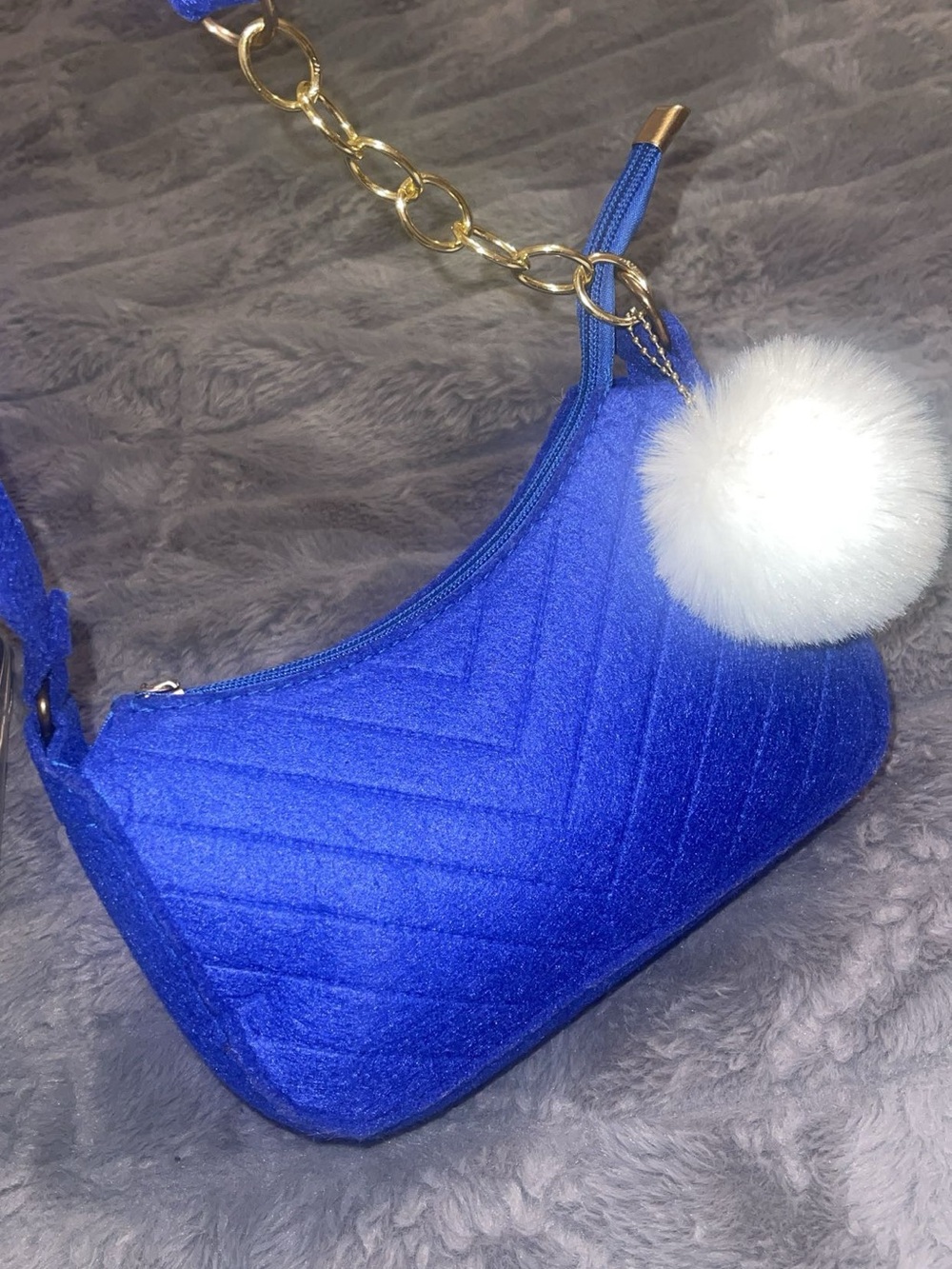 Quilted Blue Shoulder Bag with Gold Chain and White Pom Pom